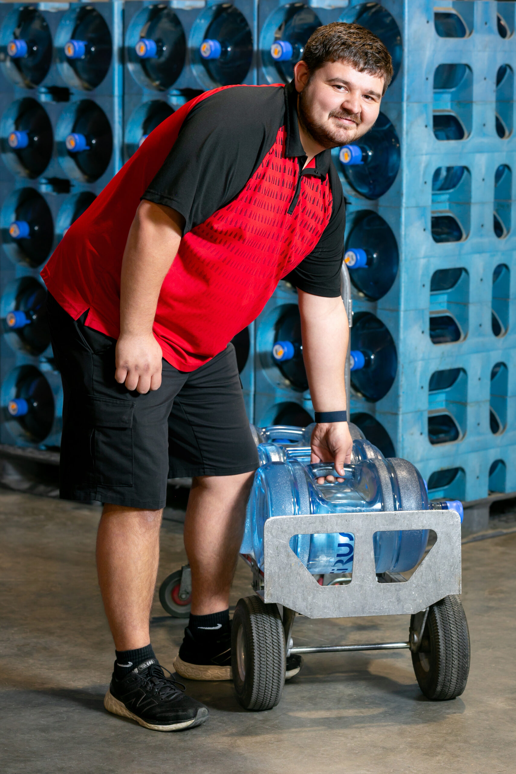 Man Takes Water Bottle from Rack